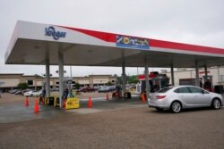 A motorist drives past this closed Kroger fuel station, in Jackson, Miss., May 12, 2021. State officials warned Tuesday that any shortages seen at individual gas stations are a result of people panic-buying.