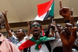 Sudanese celebrate following a signing ceremony in the capital Khartoum, Sudan, Aug. 4, 2019.