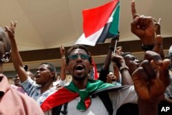 Sudanese celebrate following a signing ceremony in the capital Khartoum, Sudan, Aug. 4, 2019.