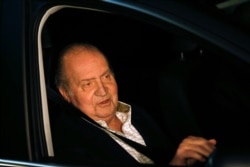 FILE - Spain's King Juan Carlos sits in a car after being released from a hospital after a hip operation in Madrid, Dec. 2, 2012.