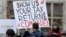 Tax FILE - A protester in Seattle holds a sign during a rally that reads "Show us your tax returns, Comrade" in reference to calls for President Donald Trump to release his tax returns and his alleged ties to Russia, April 15, 2017.