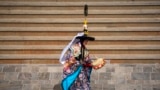 A Buddhist monk performs a traditional dance as part of the rituals during Gyalpo Losar, the Sherpa community&#39;s New Year celebration, at Shechen Monastery in Kathmandu, Nepal.