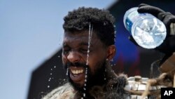 Xaviere Coleman yang mengenakan kostum Wookiee menuangkan air ke atas kepalanya untuk mendinginkan tubuh dalam foto yang diambil di Las Vegas Strip, hari Selasa, 20 Juni 2017 (foto: AP Photo/John Locher) 