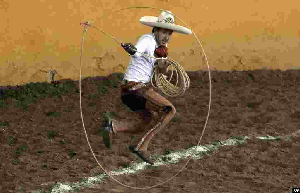 A charro performs the &quot;floreo de reata&quot; during the Charro Day celebrations in Guadalajara, Jalisco state, Mexico, Sept. 14, 2021.