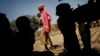 FILE - A Chadian women carries her child as others seek shade under a tree in Guelbanj, Chad, Feb. 10, 2008. Activists in Chad have launched a campaign to educate clerics and traditional rulers to help combat gender-based violence there.