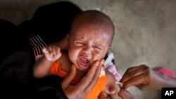 FILE - A Somali baby cries while receiving a five-in-one vaccine against several potentially fatal childhood diseases, at the Medina Maternal Child Health center in Mogadishu, Somalia 