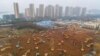 Excavators work at the construction site of a new hospital being built in a staggering 10 days to treat patients from a virus outbreak in Wuhan in China&#39;s central Hubei province.