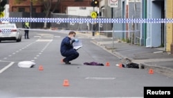 A Victoria Police employee works at the scene of a multiple shooting outside Love Machine nightclub in Prahran, Melbourne, Australia, April 14, 2019.