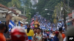 FILE - Anti-government protesters march against President Daniel Ortega and for the release of all political prisoners, in León, Nicaragua, on July 28, 2018. AP