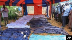 FILE — Victims of a doomsday cult are laid in body bags close to a site where dozens of bodies where found in shallow graves in the village of Shakahola, near the coastal city of Malindi, in southern Kenya on April 24, 2023.