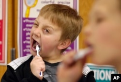 In this 2010 photo, a child learns how to take care of his teeth during a school program. (AP PHOTO)