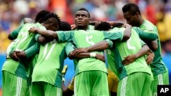 File: In this Monday, June 30, 2014 file photo, Nigeria's Emmanuel Emenike, center, looks up as his team form a huddle before the start of the second half during the World Cup round of 16 soccer match between France and Nigeria at the Estadio Nacional in 