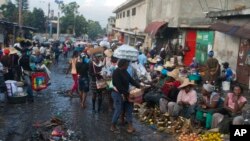 In this Dec. 4, 2019 photo, street vendors sell their produce in Petion-Ville, Haiti. 