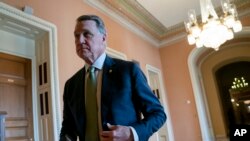 Sen. David Perdue, R-Ga., returns to the chamber following a meeting with fellow Republicans, at the Capitol in Washington, Tuesday, April 30, 2019. (AP Photo/J. Scott Applewhite)