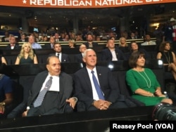 Republican vice presidential candidate Mike Pence, right, the governor of Indiana, chats with former Republican presidential candidate Bob Dole during the opening day of the Republican National Convention in Cleveland, July 18, 2016.