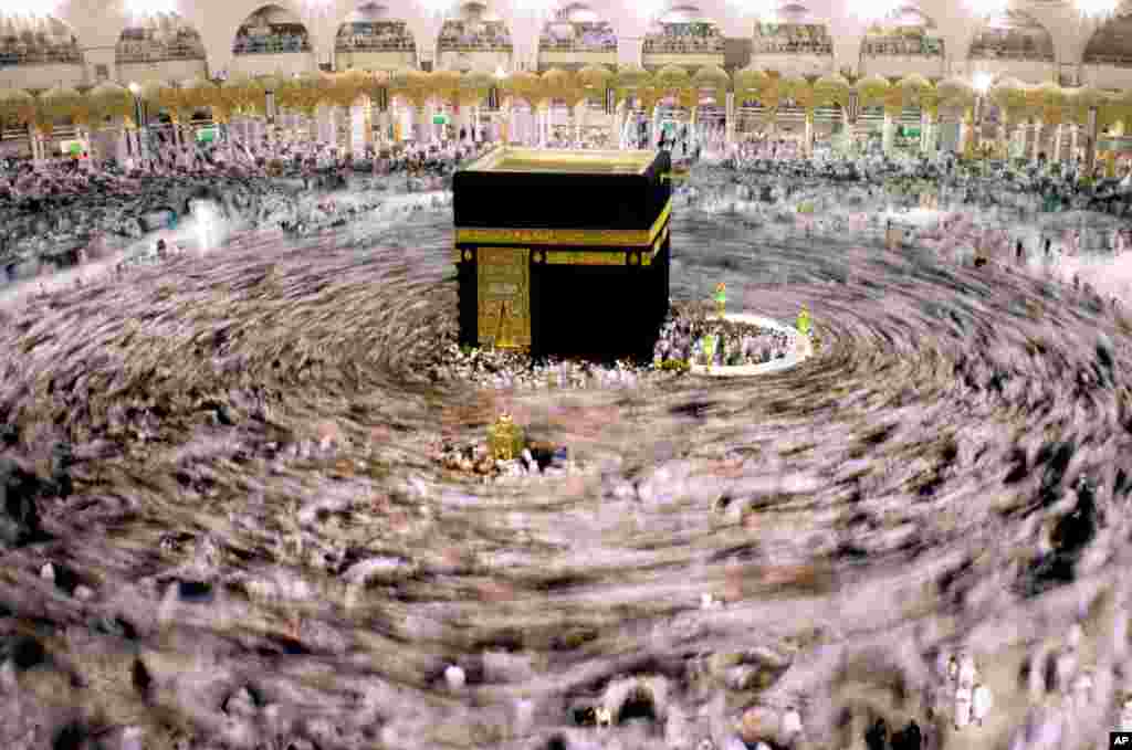 In this picture taken with low shutter speed, Muslim pilgrims walk around the Kaaba, the cubic building at the Grand Mosque, during the minor pilgrimage, known as Umrah, marking Ramadan, the holiest month in the Islamic calendar, in the Muslim holy city of Mecca, Saudi Arabia, May 30, 2018.