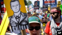 Protesters march during a rally in support of Army Pfc. Bradley Manning, whose court-martial begins Monday for the largest leak of classified documents in U.S. history, outside of Fort Meade, Maryland, June 1, 2013.