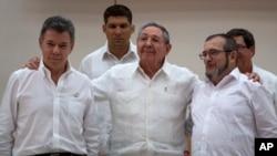 FILE - Cuba's President Raul Castro, center, stands with Colombian President Juan Manuel Santos, left, and Commander the Revolutionary Armed Forces of Colombia or FARC, Timoleon Jimenez, in Havana, Cuba, Sept. 23, 2015.