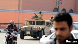 Army soldiers in military vehicles move to take up positions during the fourth anniversary of the 2011 uprising that toppled Hosni Mubarak in Cairo, Jan. 25, 2015. 