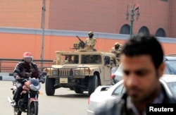 Army soldiers in military vehicles move to take up positions during the fourth anniversary of the 2011 uprising that toppled Hosni Mubarak in Cairo, Jan. 25, 2015.