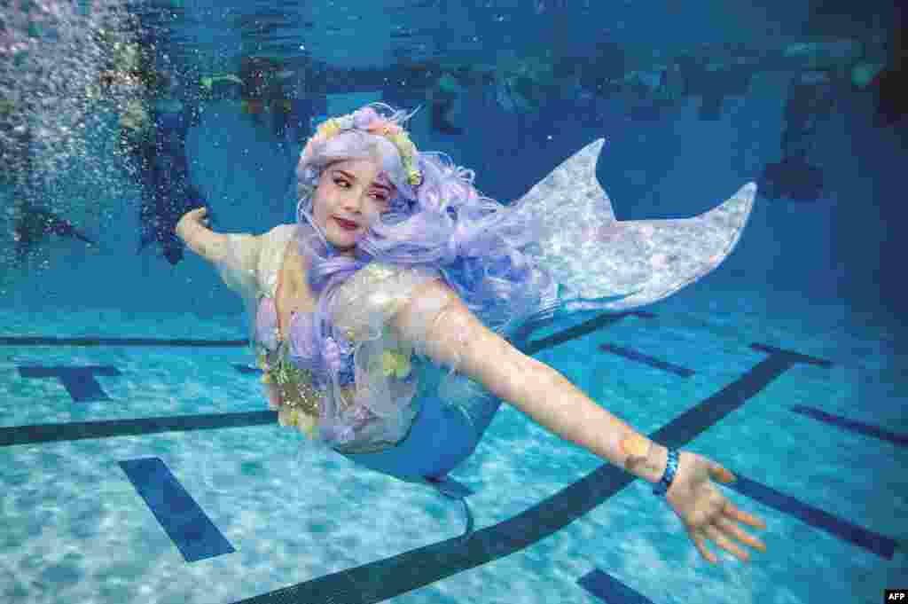 A mermaid swims during MerMagic Con at the Freedom Aquatic Center in Manassas, Virginia, Aug. 7, 2021.