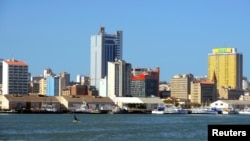 FILE - Fishing boats sit beneath the skyline of Mozambique's capital Maputo, Apr. 15, 2016. 