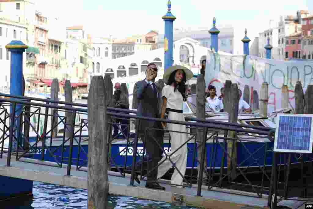 U.S. actor George Clooney and British lawyer Amal Alamuddin arrive at the palazzo Ca Farsetti in Venice, for a civil ceremony to make their wedding official. 