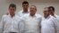 FILE - Cuba's President Raul Castro, center, stands with Colombian President Juan Manuel Santos, left, and Commander the Revolutionary Armed Forces of Colombia or FARC, Timoleon Jimenez, in Havana, Cuba, Sept. 23, 2015.