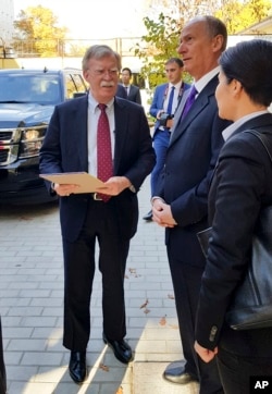 U.S. National Security Adviser John Bolton (L) and Russian Security Council chairman Nikolai Patrushev talk prior their official talks in Moscow, Russia, Oct. 22, 2018.