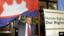 U.N. special rapporteur Surya Subedi walks through a Cambodian national flag upon his arrival in a conference room at the U.N. headquarter in Phnom Penh, file photo. 