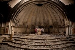 FILE - Remnants of an altar are seen in a Catholic church that was gutted by Islamic State militants, in Hamdaniya, Iraq, Dec. 5, 2016.