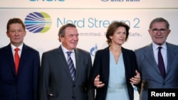 Gazprom chief Alexei Miller, from left, poses with former German Chancellor Gerhard Schroeder, Isabelle Kocher, chief executive officer of French gas and power group Engie, and Gerard Mestrallet, Engie's former chairman & CEO, now non-executive chairman, in Paris, April 24, 2017, after western partners of gas giant Gazprom agreed on financing the 9.5-billion euro ($10.32 billion) Nord Stream 2 pipeline.