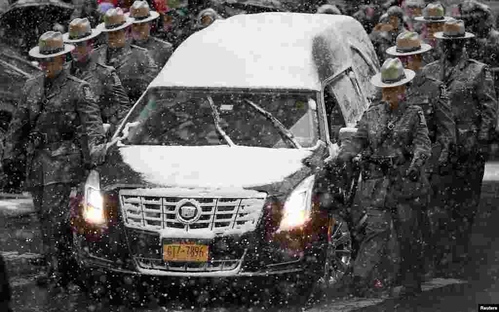 The hearse carrying the casket of former New York Governor Mario Cuomo is escorted by members of the New York State Police as it arrives at the St. Ignatius Loyola Church for funeral service in the Manhattan borough of New York.