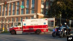 An ambulance transports Ashoka Mukpo, who contracted Ebola while working in Liberia, to the Nebraska Medical Center's specialized isolation unit in Omaha, Nebraska, Oct. 6, 2014.