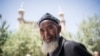 Seorang pria Muslim setempat setelah salat Jumat di depan sebuah Masjid di Hotan, di Daerah Otonomi Uighur Xinjiang, China, 23 Juni 2017. (Foto: AFP)