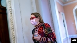 Sen. Kyrsten Sinema, D-Ariz., heads to a Democratic Caucus meeting as the Senate continues to grapple with end-of-year tasks at the Capitol in Washington, Dec. 16, 2021.