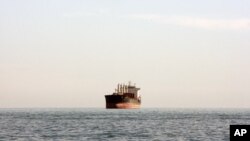 A cargo ship is seen between the Iranian city port of Bandar Abbas and Qeshm Island in the strategic waterway the Persian Gulf.