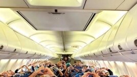 This Friday, March 27, 2020, photo provided by Southwest Airlines employee Dayartra Etheridge shows health care workers, other passengers and flight crew aboard a Southwest flight from Atlanta to New York's LaGuardia Airport.