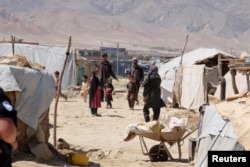 Internally displaced Afghans are pictured at a camp outside Kabul, Afghanistan, during a visit by U.N. Secretary-General Antonio Guterres, June 14, 2017.