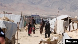 FILE - Internally displaced Afghans at a camp outside Kabul, Afghanistan, during a visit by United Nations Secretary-General Antonio Guterres June 14, 2017. UN refugee agency estimates eight million Afghans do not live in their homes, fleeing deadly conflict, poverty, unemployment and a worsening drought in Afghanistan.