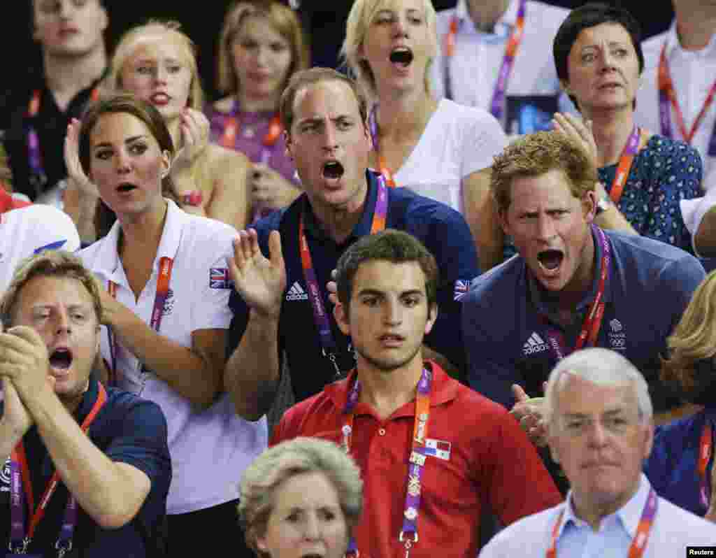 Britain's Prince William (C), his wife Catherine (L), Duchess of Cambridge and Prince Harry cheer for the British team as they watch the track cycling event at the Velodrome during the London 2012 Olympic Games August 2, 2012.