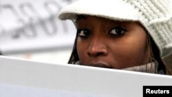 A demonstrator protests outside the City of Westminster Magistrates Court in London during an extradition hearing of Rwandan immigrant Vincent Bajinya, and others, (File photo).