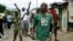 Demonstrators, some carrying machetes and stones, shout as police dismantle a barricade in the Kanyosha district of Bujumbura, Burundi, May 6, 2015. 