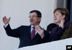 German Chancellor Angela Merkel, right, and Turkish Prime Minister Ahmet Davutoglu speak as they look toward the city center after a welcome ceremony in Ankara, Turkey, Feb. 8, 2016.