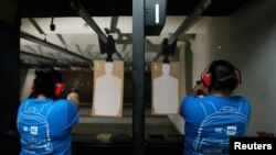 Nicole Navarro (L) and Adriana Retana, who said they wanted to improve their marksmanship after a gunman killed 22 people at a local Walmart, practice shooting at a gun range in El Paso, Texas, Aug. 12, 2019. 