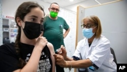 An Israeli youth receives a Pfizer-BioNTech COVID-19 vaccine in the central Israeli city of Rishon LeZion, June 6, 2021. 