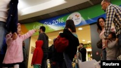 FILE - Passengers line up during a security check ahead of the 2016 Rio Olympics at Congonhas Airport in Sao Paulo, Brazil, July 18, 2016.