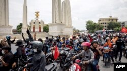 Pro-democracy activists set off on motorbikes from the Democracy Monument during a car mob protest in Bangkok on July 16, 2023 as they call on Thailand's senators to vote for Move Forward Party leader Pita Limjaroenrat in the upcoming vote for prime minis