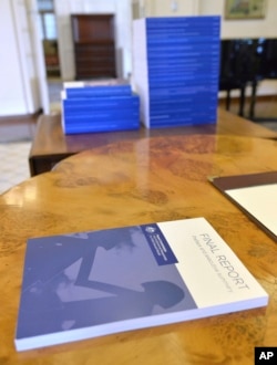 Volumes of the Final Report of the Royal Commission into Institutional Responses to Child Sexual Abuse sit on a table at Government House, in Canberra, Dec. 15, 2017. The commission delivered its final 17-volume report and 189 recommendations following a wide-ranging investigation.