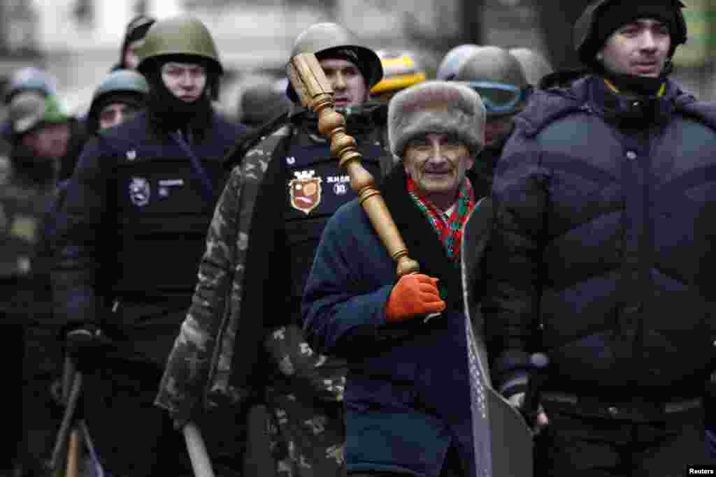 Members of self defense units stand guard at the parliament building in Kyiv, Feb. 25, 2014. 